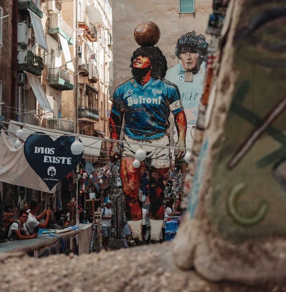 Giant mural of diego maradona in a narrow street